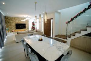 a dining room with a table and a christmas tree at Villa 360 in Calaca