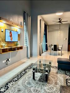 a living room with a couch and a table at Habibie Homestay-Gunung Jerai in Guar Chempedak