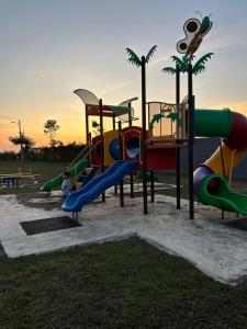 a park with a playground with a slide at Habibie Homestay-Gunung Jerai in Guar Chempedak +20 photos