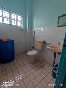 a bathroom with a toilet and a sink at Homestay Dasuqi #Musl!m only in Seremban +9 photos