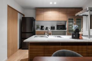 a kitchen with a sink and a refrigerator at The Verite in Asahikawa