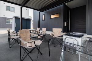 a patio with chairs and tables and a grill at The Verite in Asahikawa +49 photos