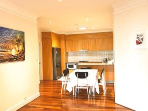 une cuisine et une salle à manger avec une table et des chaises dans l'établissement Inner North Elegance Premier Turner Living 2 Bed, 2 Bath Townhome, à Turner