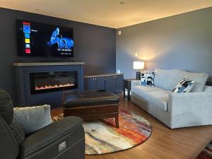 a living room with a couch and a fireplace at Rutledge Lake Retreat in Bancroft