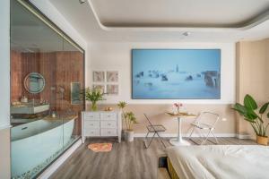 a bathroom with a large painting on the wall at Aimee House Vũ Miên in Hanoi