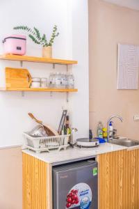 a kitchen with a sink and a dishwasher at Aimee House Vũ Miên in Hanoi