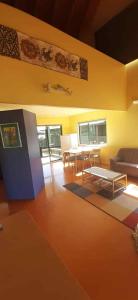 a living room with a table and a couch at Hosts on the Coast Titoki Palms in Matarangi +7 photos