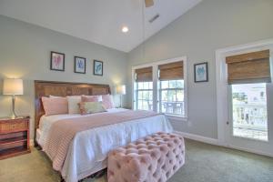 a bedroom with a large bed and two windows at Stairway to Havens - North in Myrtle Beach +17 photos