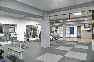 a gym with treadmills and machines in a room at Hotel Olimp in Zlatibor