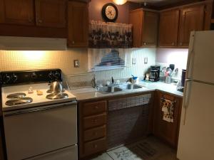 a kitchen with a sink and a refrigerator at Rainbow Springs Private 4 acre Country Retreat in Ocala