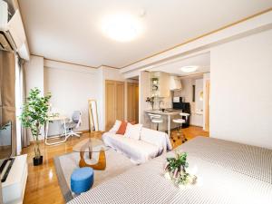 ein Wohnzimmer mit Sofa und Tisch in der Unterkunft The Global West in Niihama