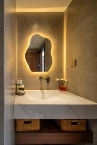 a bathroom with a sink and a mirror at Nan she in Datong +80 photos