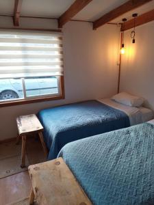 Postel nebo postele na pokoji v ubytování Hostal Costa patagonica