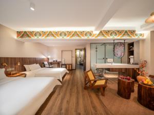 a hotel room with two beds and a piano at Nan she in Datong