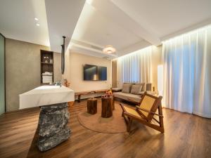 a living room with a sink and a couch at Nan she in Datong