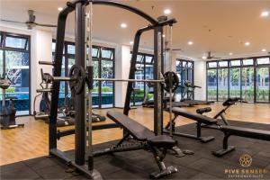 a gym with several tread machines in a room with windows at KIP Core Soho Suite by Five Senses in Sepang