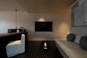 Μια τηλεόραση ή/και κέντρο ψυχαγωγίας στο Dali Rushi Jiuxi Sea View Holiday Inn +24 φωτογραφίες