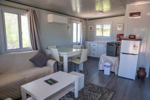 a kitchen and living room with a couch and a table at The Holiday Hut in Lightning Ridge