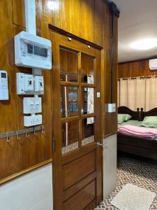 a room with a door and a bedroom with a bed at อิ๊กขะหลิ๊ก โฮมสเตย์ริมน้ำน่าน in Nan