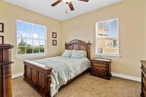 a bedroom with a bed and two windows at 128 Mediterranean Way in Indian Harbour Beach +30 photos