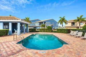 a house with a swimming pool in a yard at 128 Mediterranean Way in Indian Harbour Beach