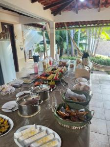 a buffet of food on a table with food at Pousada Alter Villa Suítes in Alter do Chao