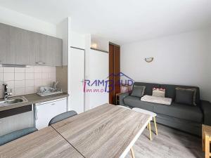 a kitchen and living room with a table and a couch at Studio Cabine Rénové - 4 Couchages - Centre de Valloire - FR-1-854-46 in Valloire