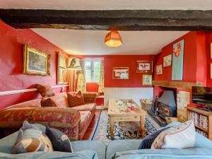 ein Wohnzimmer mit roten Wänden und Sofas in der Unterkunft 2 bed property in Lechlade 40194 in Langford