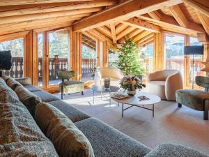 a living room with a large couch and chairs at Chalet exquis à Courchevel 1850, près des pistes, jusqu'à 10 personnes - FR-1-772-5 in Courchevel