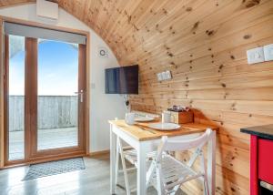 a dining room with a table and a tv at South View Retreat in Carlton