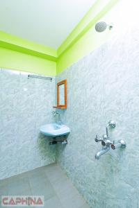 a bathroom with a sink and a shower at Caphina Coastal Comforts in Benaulim +40 photos