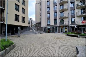 an empty parking lot in front of some buildings at New Studio In Oslo Namai in Vilnius