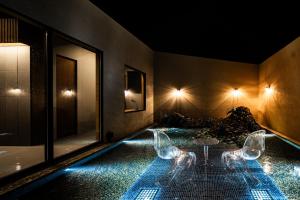 a house with a swimming pool at night at BLUE BLACK blue black in Karatsu
