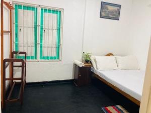 a small room with a bed and a window at Sen Villa - Rathgama in Ratgama Hegoda