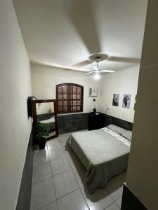 Ένα ή περισσότερα κρεβάτια σε δωμάτιο στο Hospedaria Clã do Cla