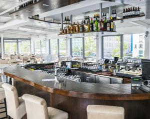 a bar in a restaurant with a lot of windows at Botel Gracia in Bratislava