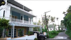 a truck parked in front of a building at Kaattil Homes in Varkala +31 photos