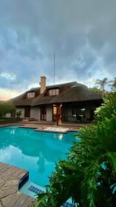 a house with a large swimming pool in front of it at LAPA ROOF in Sandton