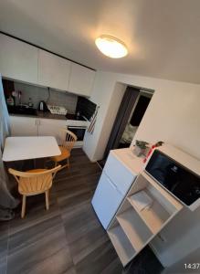 a small kitchen and dining room with a table and a table at trygga huset in Sigtuna