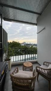 a balcony with two chairs and a large window at Home Homestay in Hanoi