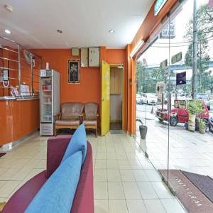 a waiting room with a blue couch in a building at Haven Hotel Cheras in Kuala Lumpur