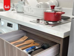 a drawer in a kitchen with a pot on a stove at Modern Haven Suite in Hat Yai in Ban Thung Ngai