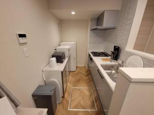 a small kitchen with a sink and a counter at ローズパーク十番館 in Narashino +118 photos