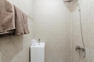 a bathroom with a shower with a toilet and a shower at Urbanview near Mall Botania 2 in Pulau Sembakau Besar +25 photos