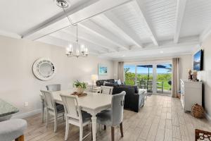a dining room and living room with a table and chairs at 1045 Wave Crest Avenue in Indialantic