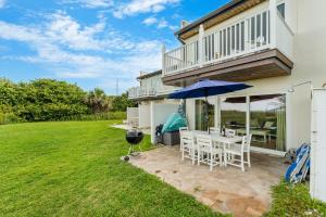 a patio with a table and an umbrella at 1045 Wave Crest Avenue in Indialantic