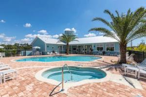 a resort with a swimming pool and a building at Cape Crossing 104 in Merritt Island