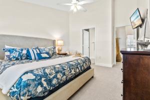 a bedroom with a bed and a ceiling fan at Cape Crossing 104 in Merritt Island +46 photos