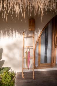 a pair of umbrellas sitting next to a door at Villa Nyantara - Private tropical villa in Gili Islands