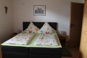 a bed with two pillows on it in a room at Ferienwohnungen Kasparbauer in Regen